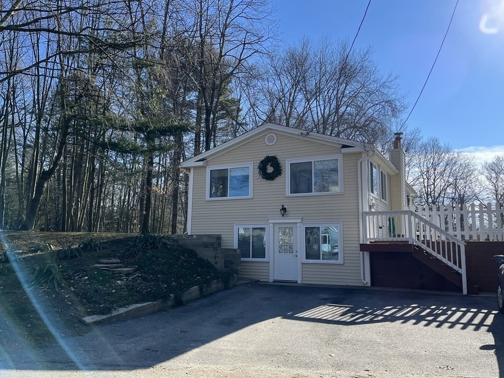 49 Hayden Pond Road, Unit 2 Dudley, MA 01571 - Photo 1 of 18 a front view of a house with a yard