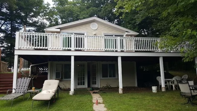 a front view of a house with a yard table and chairs