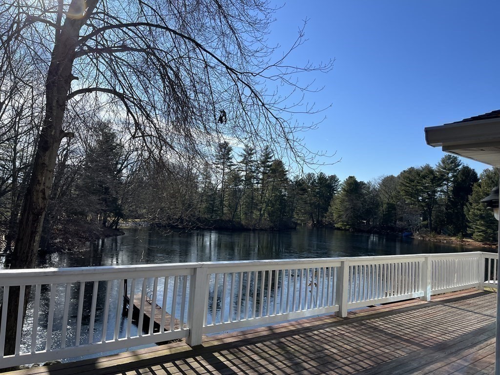 49 Hayden Pond Road, Unit 2 Dudley, MA 01571 - Photo 4 of 18 a view of deck with two chairs and wooden fence