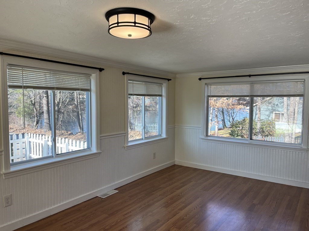 49 Hayden Pond Road, Unit 2 Dudley, MA 01571 - Photo 10 of 18 a view of an empty room with wooden floor and a window