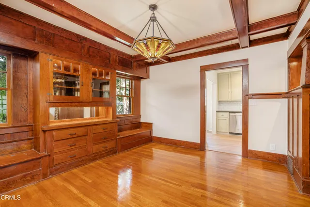 a kitchen that has a sink stainless steel appliances and cabinets