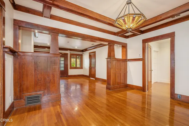 a kitchen that has a stove and a wooden floor
