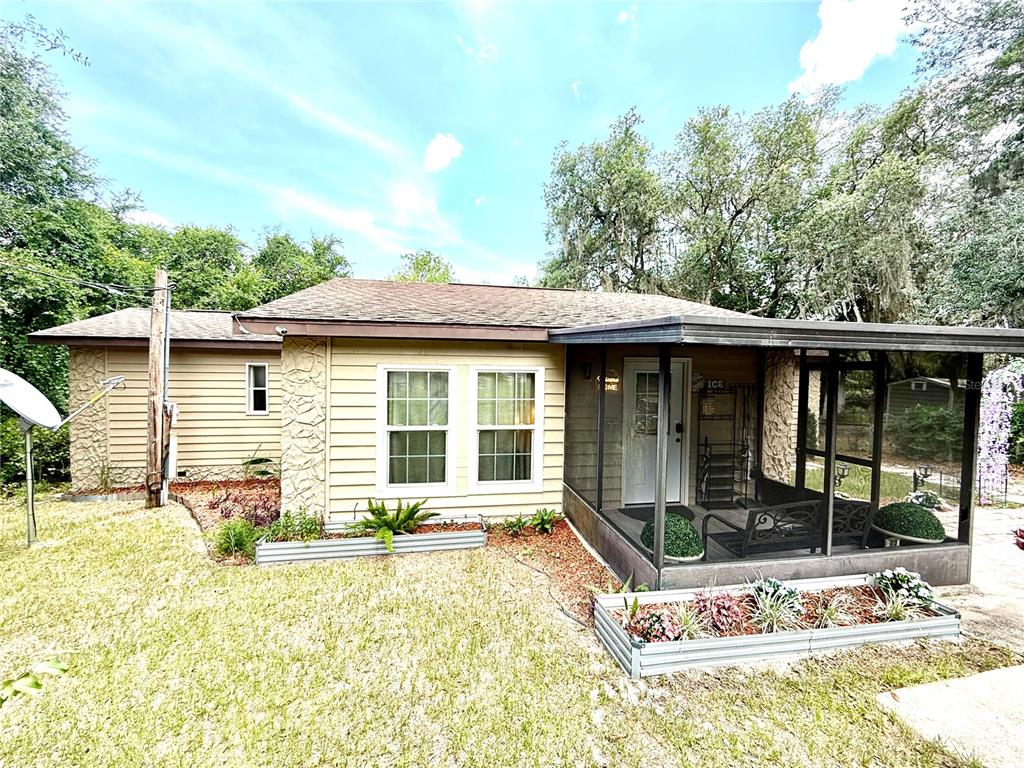 208 Ashley Street Hawthorne, FL 32640 - Photo 27 of 32 a front view of a house with a yard outdoor seating and garage