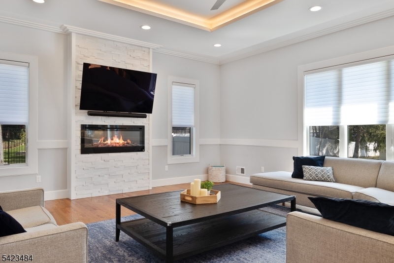 57 Walnut Street Livingston, NJ 07039 - Photo 18 of 43 a living room with furniture and a flat screen tv
