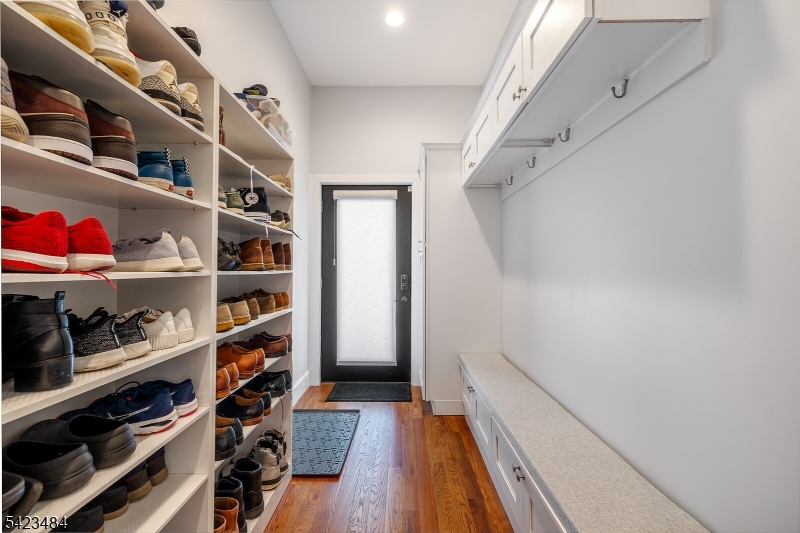 57 Walnut Street Livingston, NJ 07039 - Photo 20 of 43 a view of walk in closet with clothes and shoes