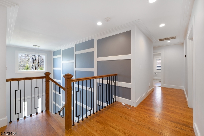 57 Walnut Street Livingston, NJ 07039 - Photo 21 of 43 a view of a hallway with wooden floor and windows