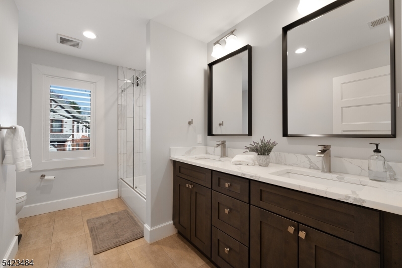 57 Walnut Street Livingston, NJ 07039 - Photo 23 of 43 a spacious bathroom with double vanity sink a mirror and a bathtub