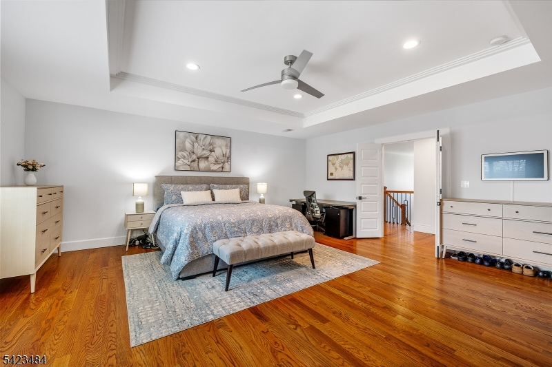 57 Walnut Street Livingston, NJ 07039 - Photo 25 of 43 a spacious bedroom with a bed and wooden floor