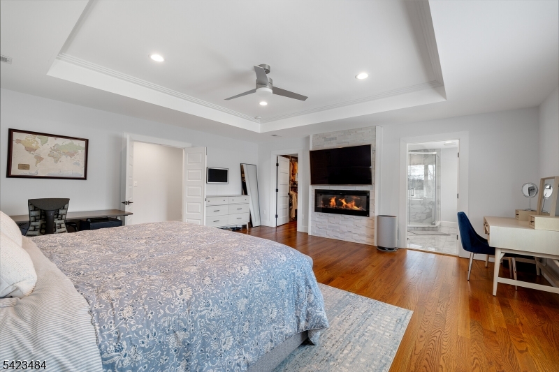 57 Walnut Street Livingston, NJ 07039 - Photo 26 of 43 a spacious bedroom with a bed and a flat screen tv