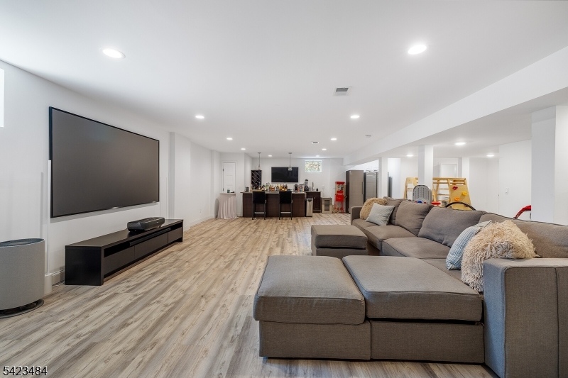 57 Walnut Street Livingston, NJ 07039 - Photo 32 of 43 a living room with furniture and a flat screen tv
