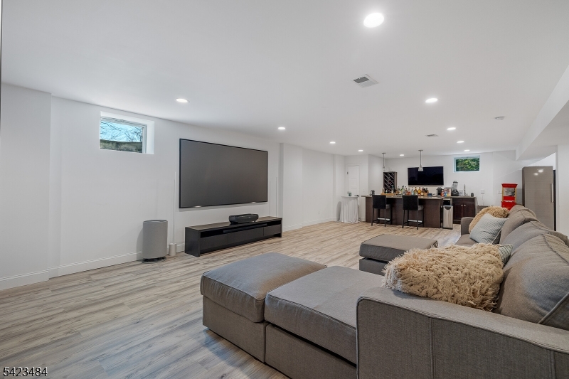 57 Walnut Street Livingston, NJ 07039 - Photo 33 of 43 a living room with furniture and a flat screen tv