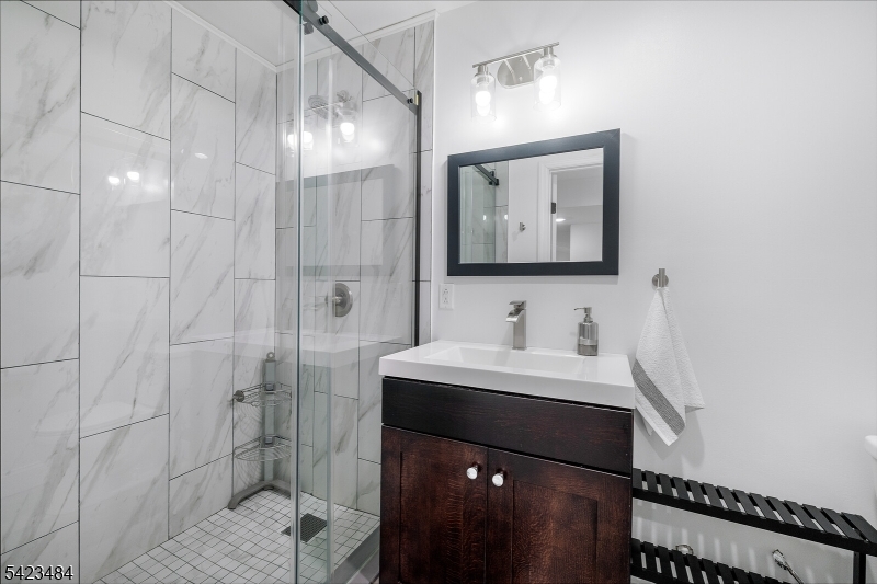 57 Walnut Street Livingston, NJ 07039 - Photo 36 of 43 a bathroom with a sink vanity and a mirror