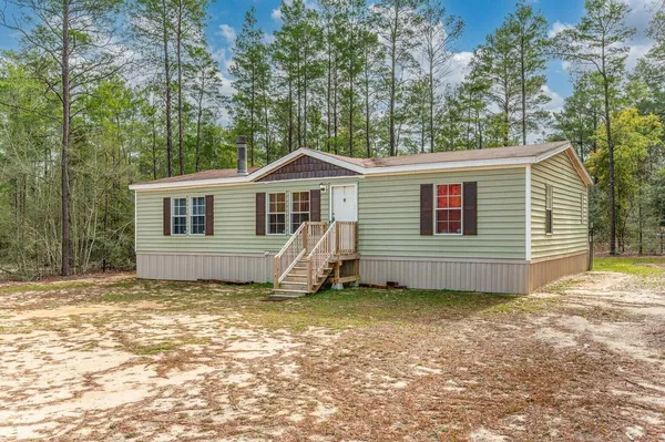 a house with trees in the background
