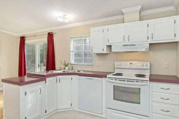 a kitchen with stainless steel appliances granite countertop a stove and a microwave