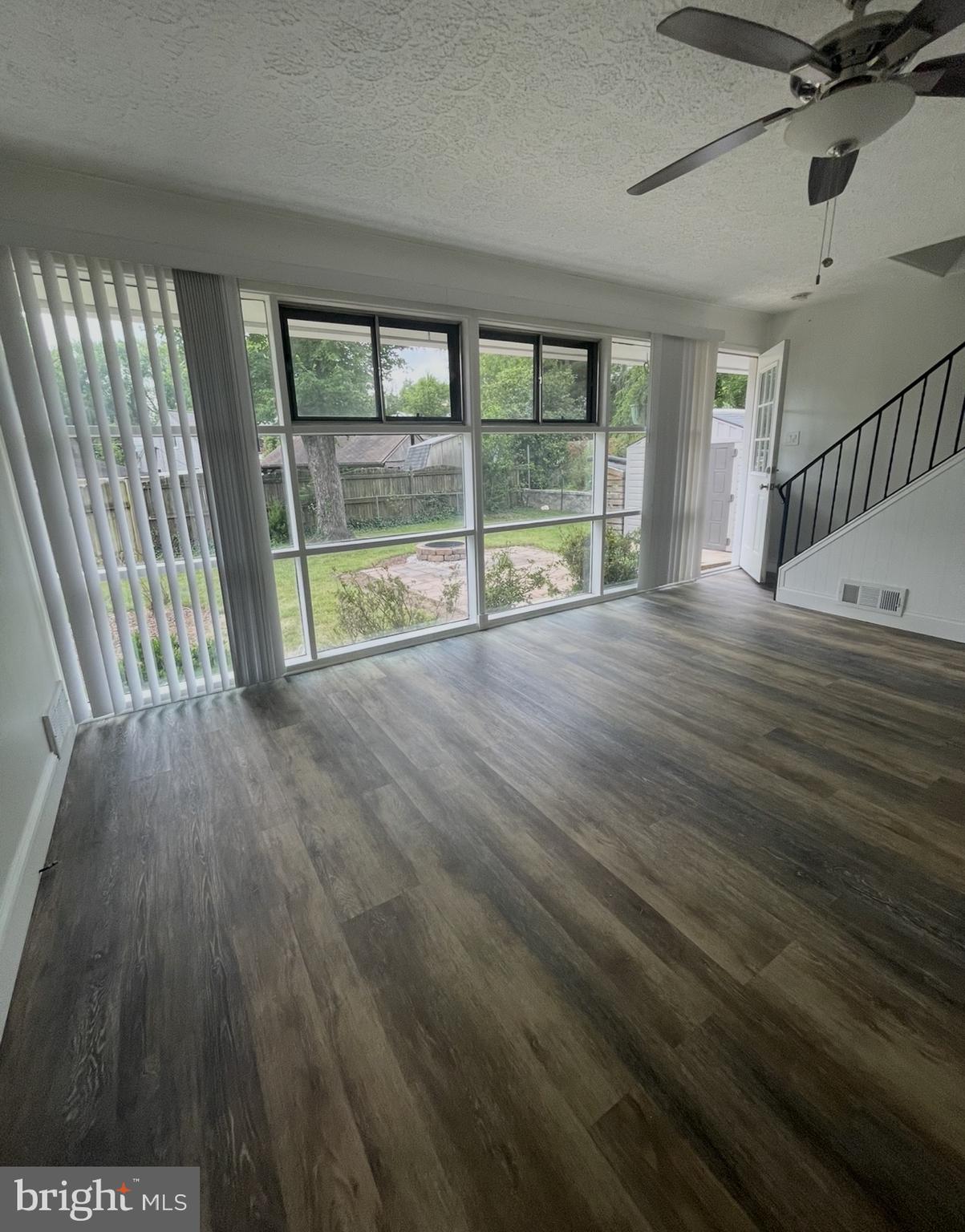 5700 Stillwell Road Rockville, MD 20851 - Photo 12 of 19 a view of an empty room with wooden floor and a window