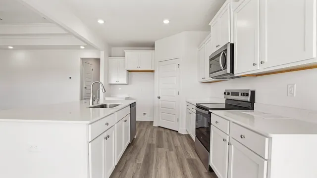 a bathroom with a sink a large mirror and shower
