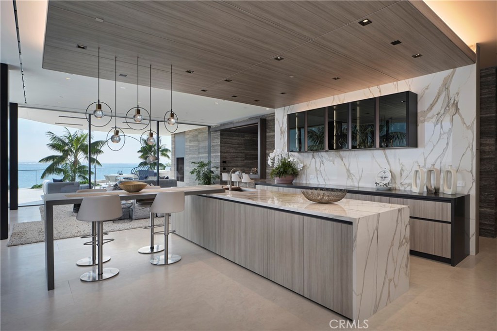 3 The Point Coronado, CA 92118 - Photo 13 of 53 a kitchen with stainless steel appliances granite countertop a sink and a microwave