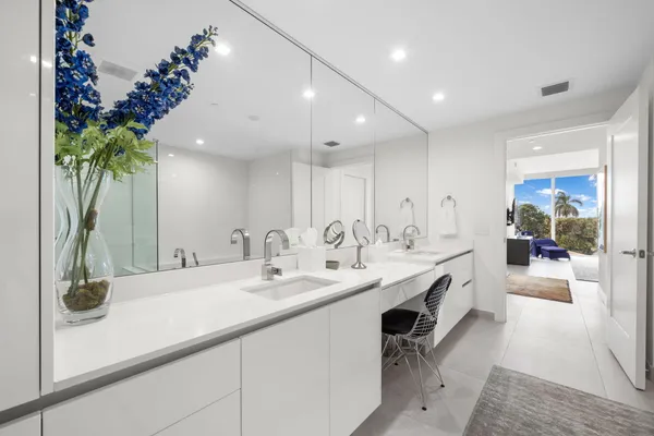 a bathroom with a double vanity sink and a mirror