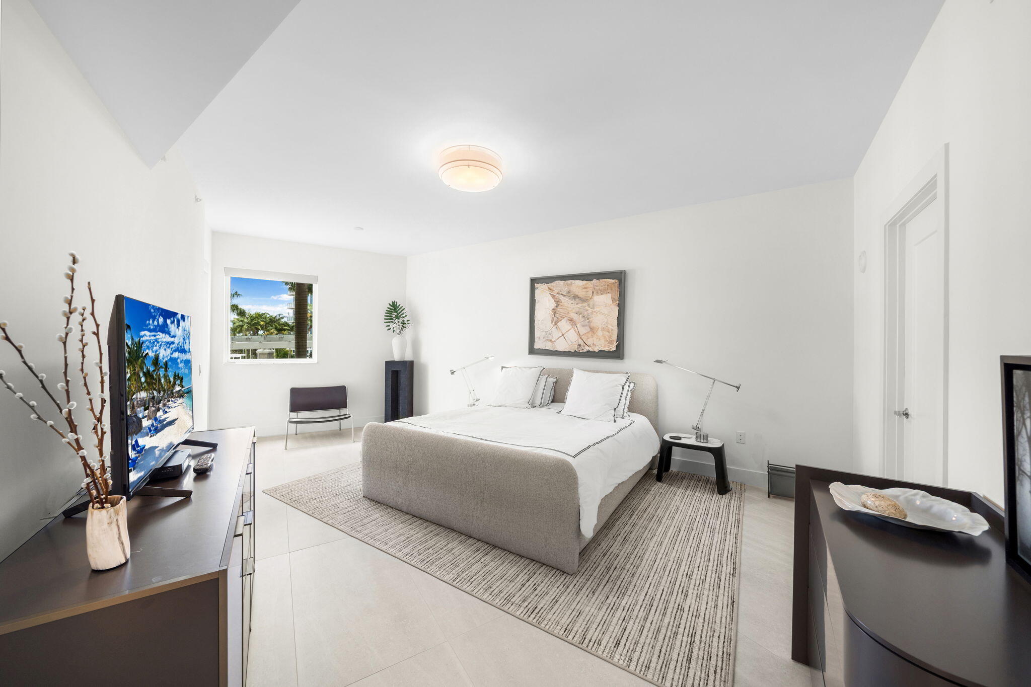 20155 Boca W Drive, Unit C201 Boca Raton, FL 33434 - Photo 15 of 42 a bedroom with a bed and a flat screen tv