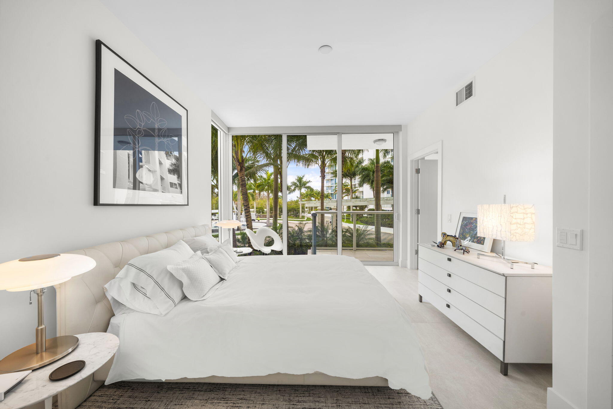 20155 Boca W Drive, Unit C201 Boca Raton, FL 33434 - Photo 19 of 42 a spacious bedroom with a large bed and a window