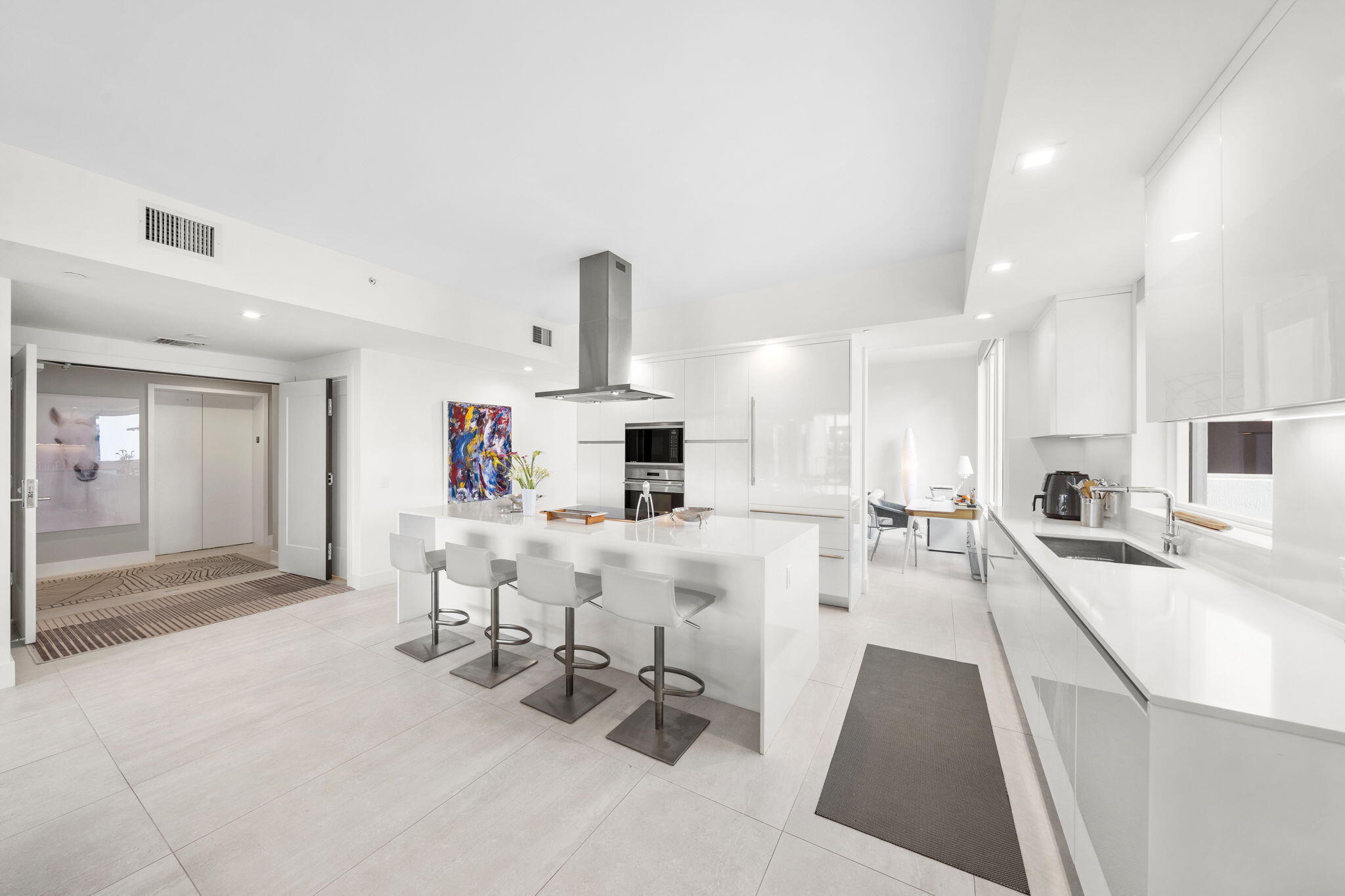 20155 Boca W Drive, Unit C201 Boca Raton, FL 33434 - Photo 7 of 42 a living room with furniture a flat screen tv and a table