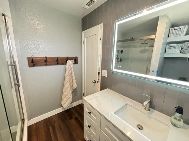 a bathroom with a sink and mirror
