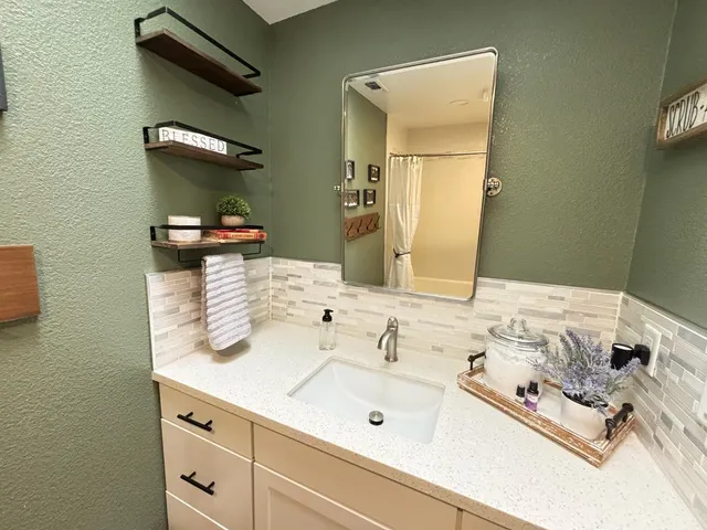a bathroom with a sink and a mirror