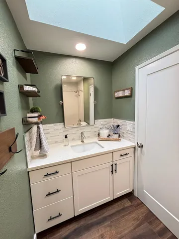 a bathroom with a double vanity sink and a mirror