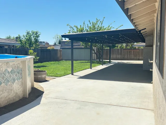 a view of a backyard with wooden fence