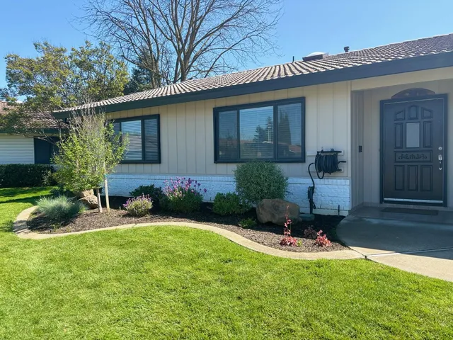 a front view of a house with a yard