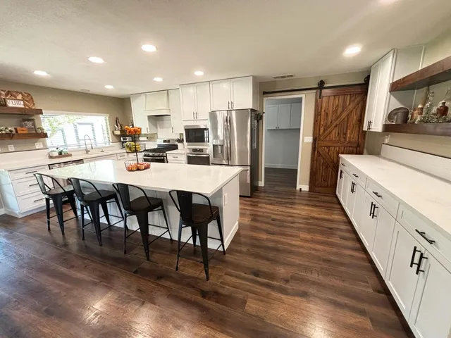 a large kitchen with stainless steel appliances lots of counter space and breakfast area