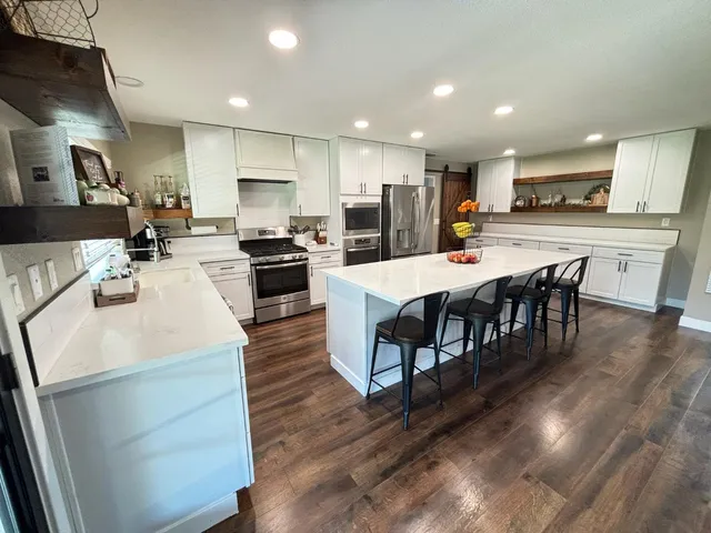 a large kitchen with a table and chairs