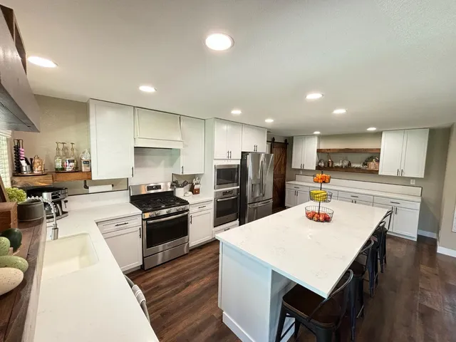 a large kitchen with a table and chairs