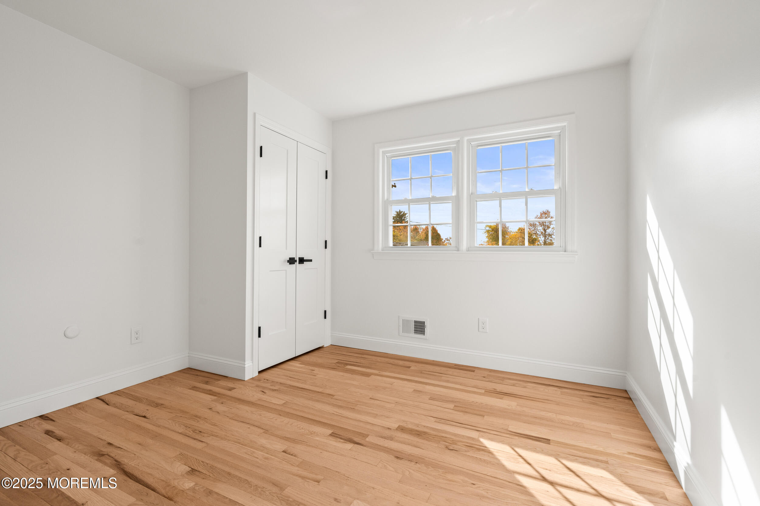 3412 Brandon Road Belmar, NJ 07719 - Photo 31 of 48 a view of empty room with wooden floor and fan