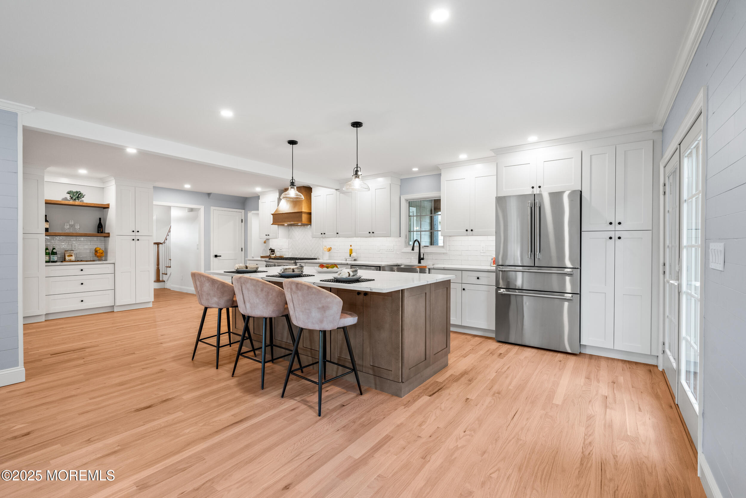 3412 Brandon Road Belmar, NJ 07719 - Photo 10 of 48 a kitchen with stainless steel appliances kitchen island wooden floors and refrigerator