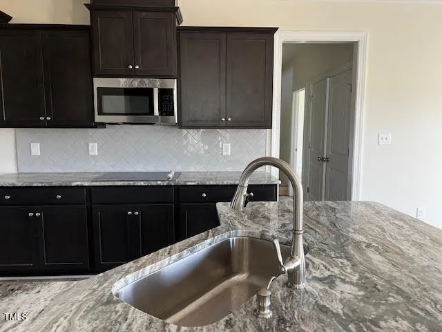 a kitchen with a sink and a stove