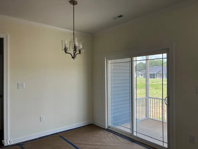 a view of a room with wooden floor and windows