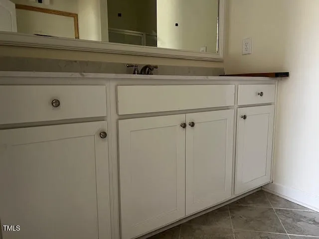 a bathroom with a sink and glass door