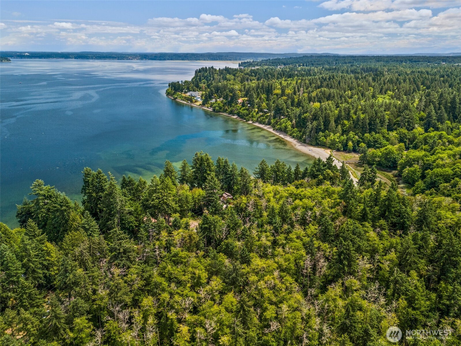 7605 Sandy Point Road Northeast Olympia, WA 98516 - Photo 11 of 25 a view of a lake with a yard