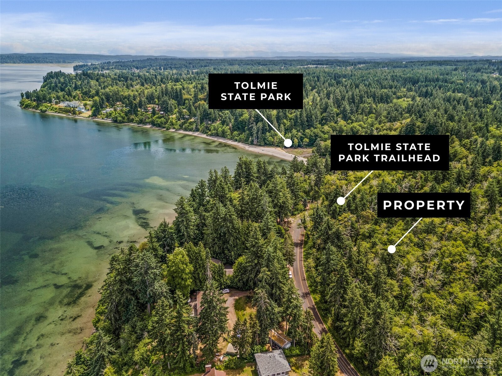 7605 Sandy Point Road Northeast Olympia, WA 98516 - Photo 12 of 25 a sign that is sitting on a beach