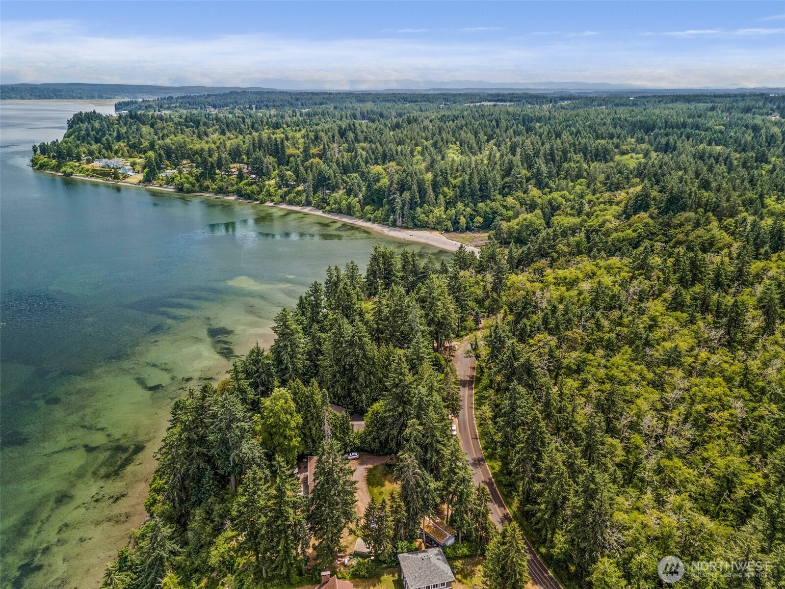 7605 Sandy Point Road Northeast Olympia, WA 98516 - Photo 2 of 25 an aerial view of residential houses with outdoor space and lake view