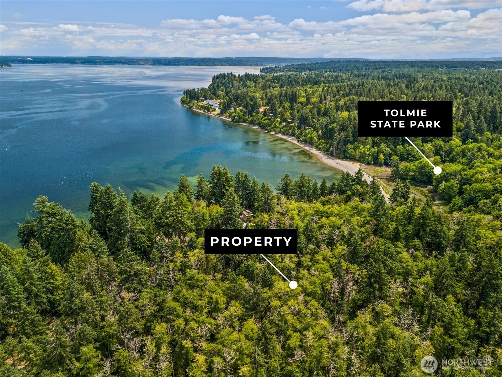 7605 Sandy Point Road Northeast Olympia, WA 98516 - Photo 3 of 25 a sign on the side of a building