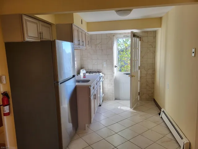 a utility room with cabinets washer and dryer