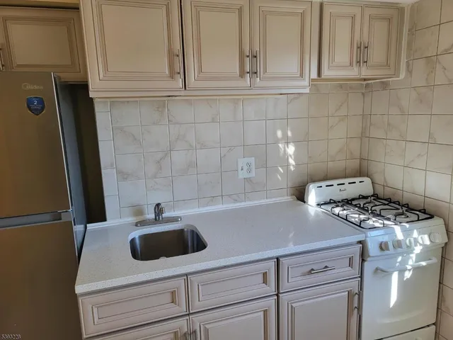 a kitchen with a sink and cabinets