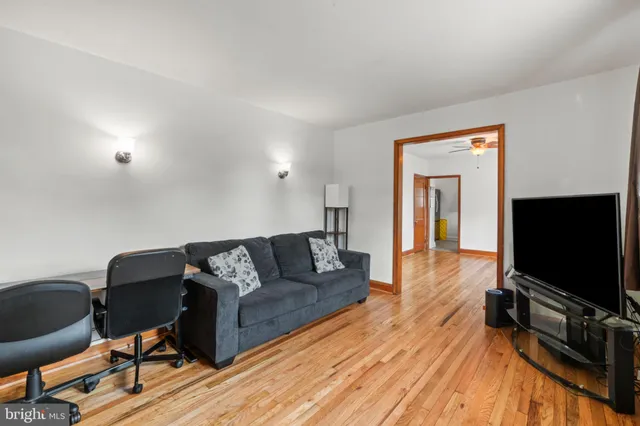 a living room with couches and a flat screen tv