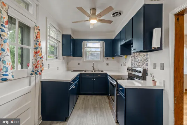 a kitchen with a sink stove and microwave