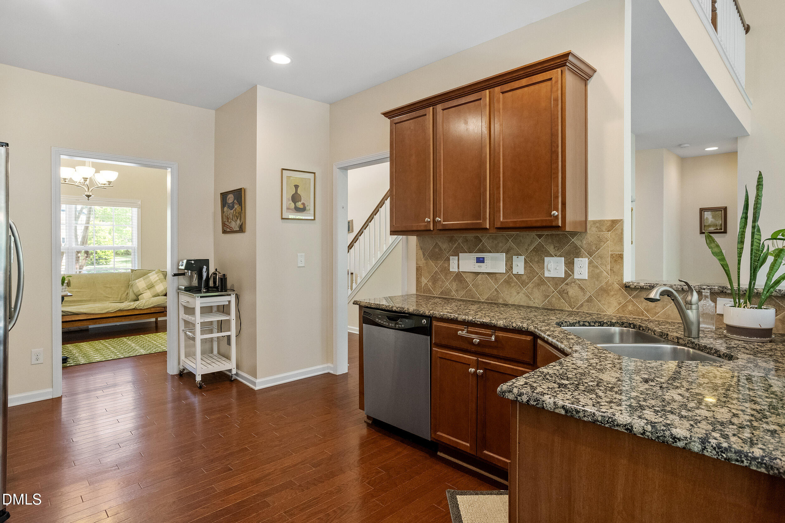 235 Strolling Way Durham, NC 27707 - Photo 14 of 32 a kitchen with stainless steel appliances granite countertop a sink stove and cabinets