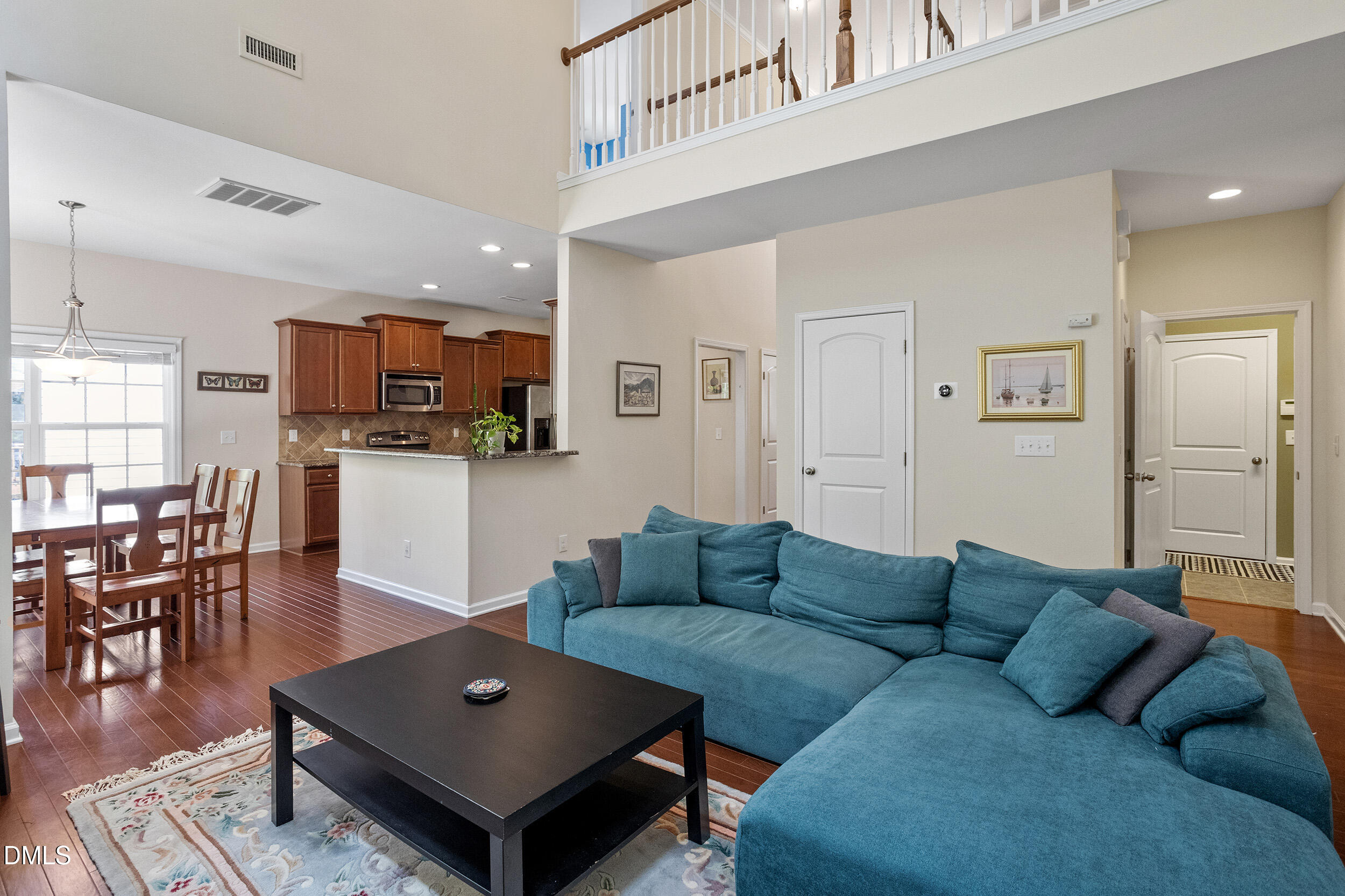 235 Strolling Way Durham, NC 27707 - Photo 17 of 32 a living room with furniture a dining table and kitchen view