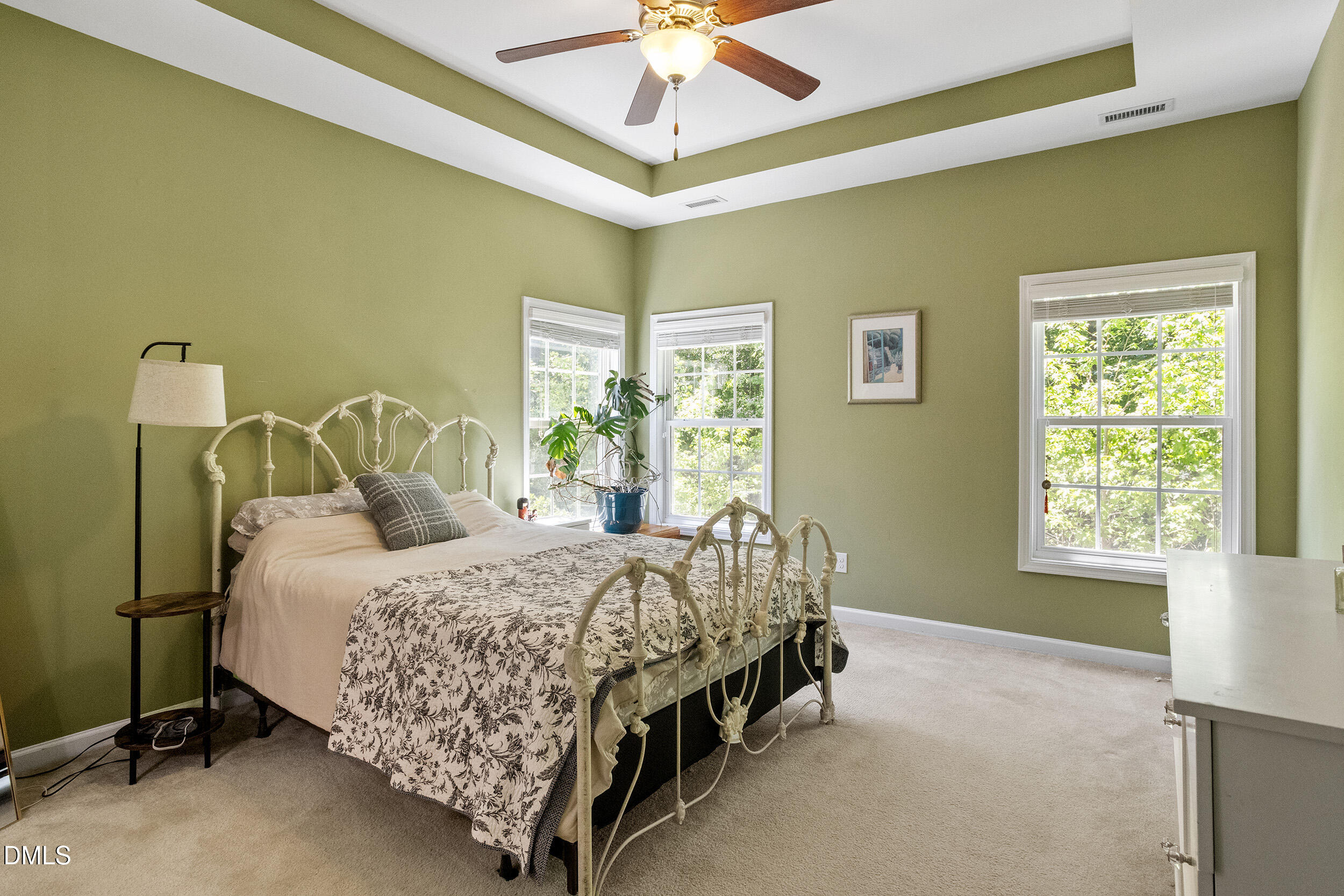 235 Strolling Way Durham, NC 27707 - Photo 20 of 32 a bedroom with a bed bed and a chandelier