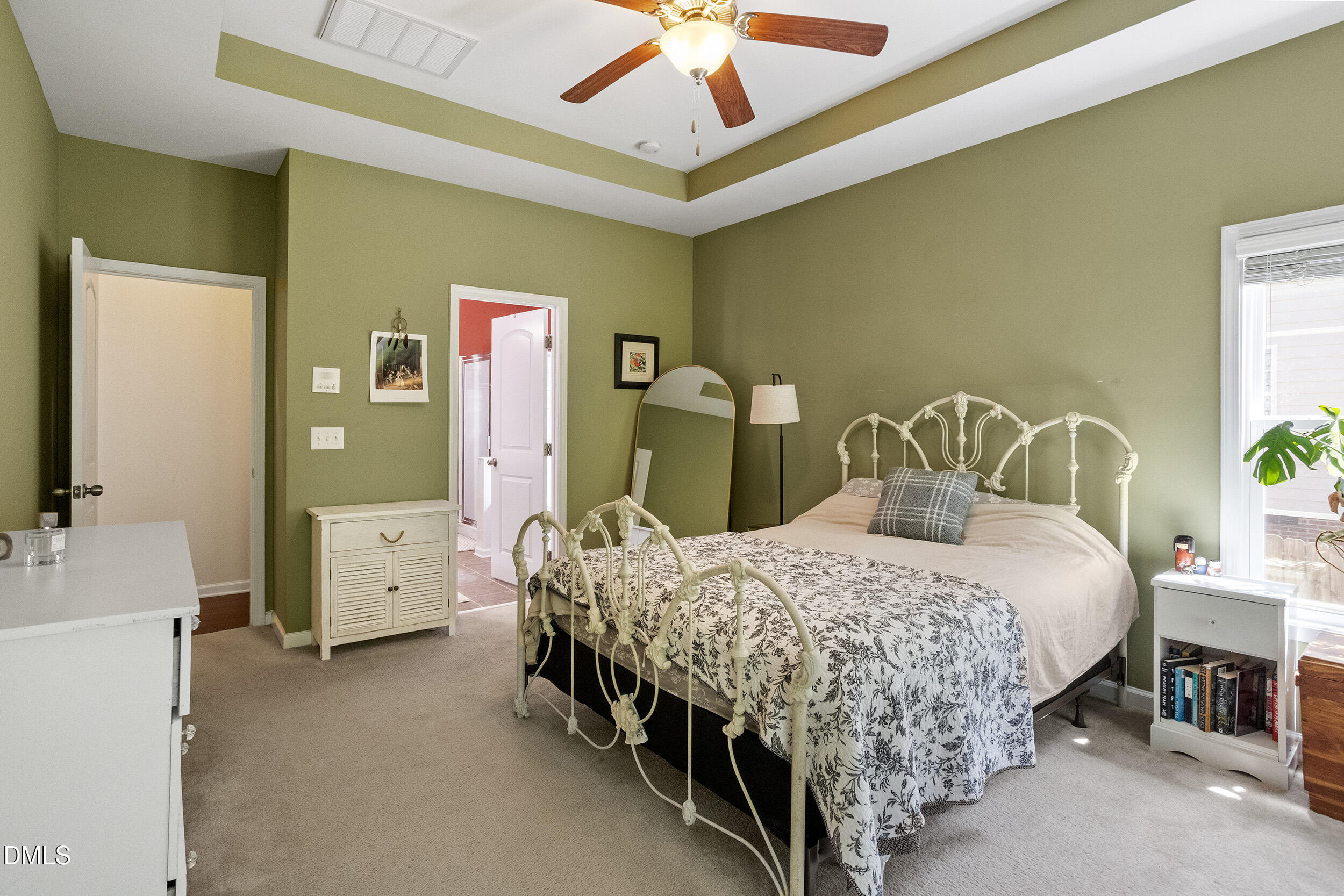 235 Strolling Way Durham, NC 27707 - Photo 21 of 32 a bedroom with a bed and a chandelier